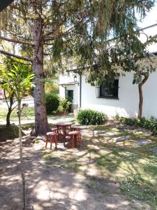 a picnic table in front of a building with trees at Xeitosa II, en el centro de Vigo in Vigo