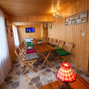 a dining room with a wooden table and chairs at Sighnaghi Art Hotel in Sighnaghi
