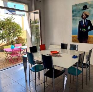 a dining room with a white table and chairs at La Pause Bleue in Dinard