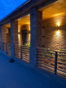 a brick building with a wooden fence on it at La casa di Elena in Reni