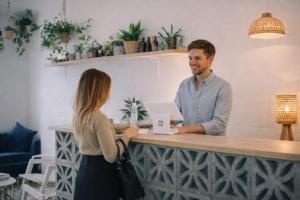 a man and a woman standing at a counter at Appartements Entiers - Centre de Tournai in Tournai