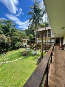 a view of the garden from the porch of a house at Flat Salto Dagua Penedo in Penedo