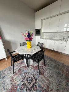 eine Küche mit einem Tisch, auf dem eine Blumenvase steht in der Unterkunft Dream flat in Pilsen