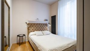 a bedroom with a large bed and a window at Mariposa in Lecco +17 photos