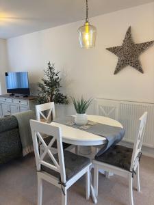 ein Esszimmer mit einem Tisch und zwei Sternen an der Wand in der Unterkunft Oakfield View in Credenhill + 5 Fotos