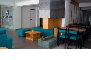 a living room with a blue couch and a table at Hanaqua Cusco Hotel in Cusco +26 photos