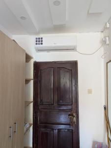 a door in a room with a ceiling fan at Belle Atelier in Ukunda +21 photos