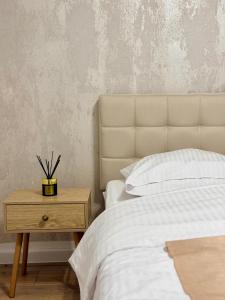 a bedroom with a bed and a nightstand next to a bed sidx sidx sidx at Apartament KJ Tomice in Tomice