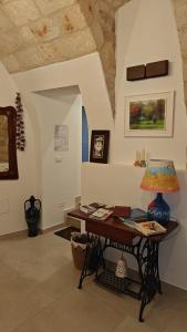 a room with a table with a lamp on it at TerraCielo in Bisceglie +26 photos