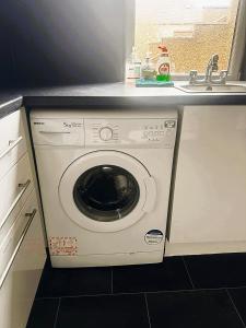 a washing machine in a kitchen next to a sink at 12A-2 Stobhill Road in Arniston