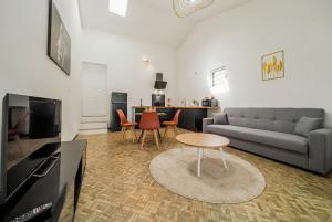 a living room with a couch and a table at Villa Cocon Jacuzzi in Saint-Pierre