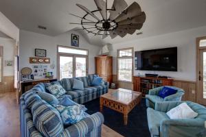 a living room with blue couches and a ceiling fan at 7678 - Drumstick in Avon