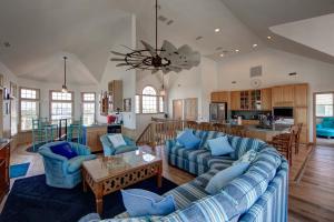 a living room with blue couches and a kitchen at 7678 - Drumstick in Avon