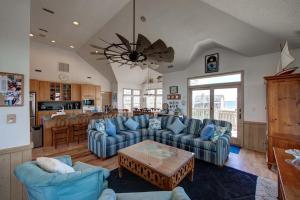a living room with blue couches and a kitchen at 7678 - Drumstick in Avon