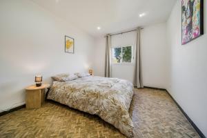 a bedroom with a bed and a window at Villa Cocon Jacuzzi in Saint-Pierre
