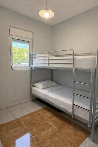 a room with two bunk beds and a window at Casa Marianna-Luxury Riviera Retreat in Anavyssos
