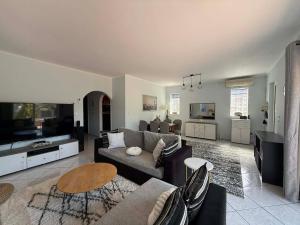 a living room with a couch and a table at Casa Marianna-Luxury Riviera Retreat in Anavyssos