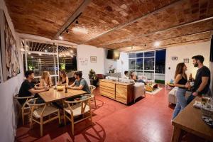 a group of people sitting around a table in a room at Hostal Nube Mia Guadalajara in Guadalajara