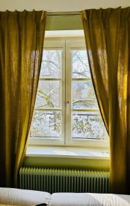 a window with curtains and a radiator in front thereof at Villa Conte Private Urban Hideaway in Wels