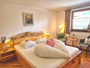 a bedroom with a bed with two pillows on it at Gästehaus Watzmannblick in Bischofswiesen