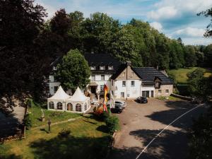 an aerial view of a large house with a tent at Landhotel Herscheider Mühle in Herscheid