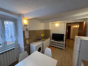 a small kitchen with a table and a television at Alba in Mele