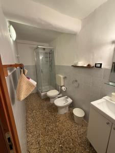 a bathroom with two toilets and a shower and a sink at Alba in Mele +23 photos