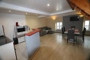 a living room with a kitchen and a dining room at Appart Hotel cholet centre in Cholet