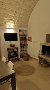 a living room with a tv and a fireplace at Alle volte… in Bisceglie