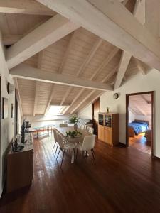 a living room with a table and chairs and a bed at Palmaria in Deiva Marina