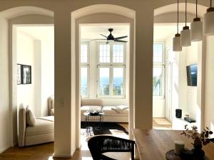 a living room with a couch and a ceiling fan at Wohlfühl-Apartment Elbtal in Radebeul