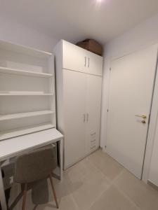 a white room with a desk and a closet at PisoCentro in Santander