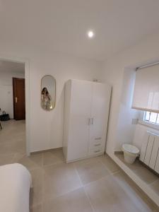a room with a white cabinet and a mirror at PisoCentro in Santander