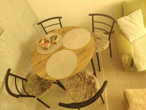 a wooden table and chairs with food on it at Apartman Vera in Bileća
