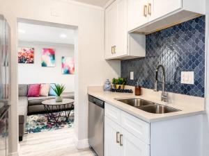 a kitchen with a sink and a living room at NEW Beach Cozy Bungalow 2B Mins-beach&downtown in Clearwater +66 photos