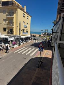 an empty street with a building and a street sign at Rosa Somhome in Peniscola +3 photos