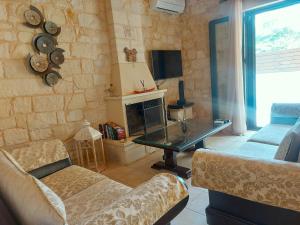 a living room with a couch and a fireplace at Villa Christy in Stalos