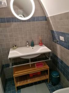 a bathroom with a sink and a mirror at La casetta nel cuore di Sciò in Gioia del Colle