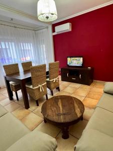 a living room with a table and chairs and a couch at Rosa Somhome in Peniscola