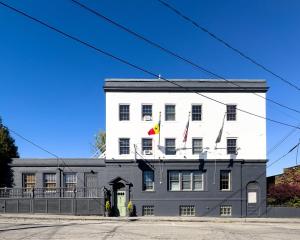 a large white building with two flags on it at The Lindsey Hotel in Rockland