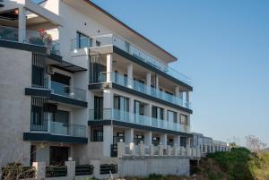 an apartment building with balconies on a hill at Студия Морска хармония in Sozopol