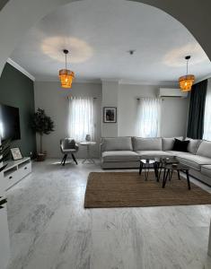 a living room with a couch and a table at Animus House #1 Apartment, Peraia in Perea