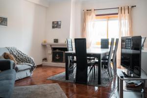 a living room with a table and chairs and a couch at Casa do Rodrigo in Mondim de Basto