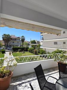 a balcony with chairs and a view of a building at Animus House #1 Apartment, Peraia in Perea
