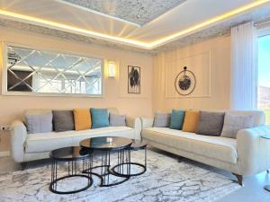 a living room with two couches and a table at Villa Panorama View Brezovica in Brezovica