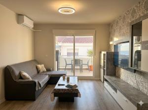 a living room with a couch and a television at TAJ house center altea #B in Altea