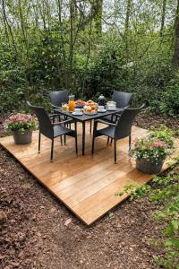 a table and chairs sitting on a wooden deck at La Tiny House de Nanou in Rochefort