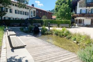 a park with benches and a pond in front of a building at Maisonette Wohnung am Tegernsee in Bad Wiessee