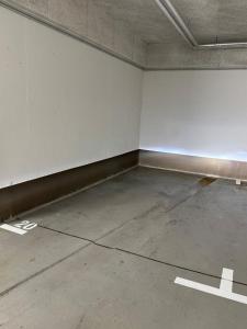 an empty room with white walls and a concrete floor at Maisonette Wohnung am Tegernsee in Bad Wiessee