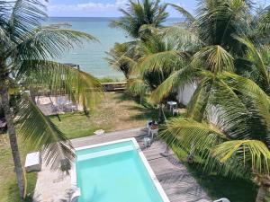 a swimming pool with a view of the ocean at Kitnet Terreo Privada 1 in Conde